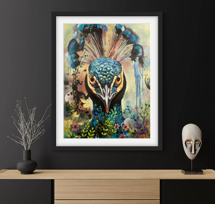 Commanding peacock portrait 'Regal Resolve' by Tash Bardot displayed above a contemporary sideboard on a striking black wall. The direct-gaze fine art print provides an authoritative focal point and immediate visual relief.