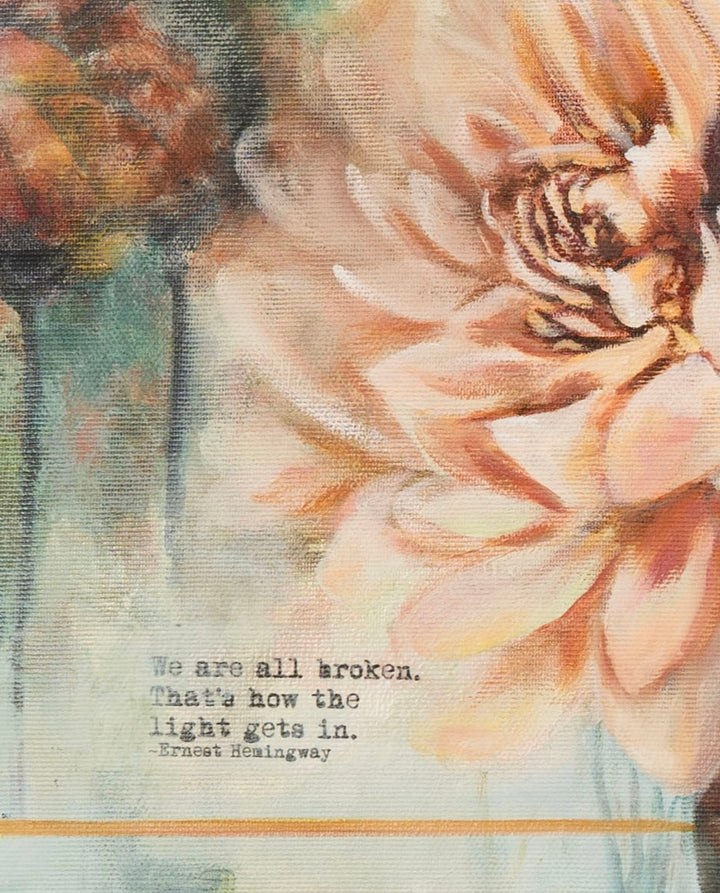 Close-up detail of 'Silent Strength' by Tash Bardot, focusing on the expressive peach floral brushstrokes and the stamped quote, 'We are all broken. That's how the light gets in.'